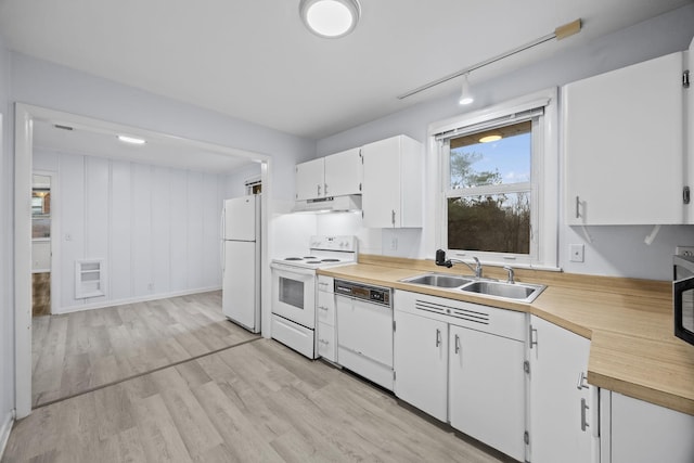 kitchen with rail lighting, sink, light wood-type flooring, white cabinets, and white appliances