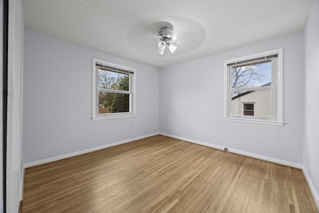 empty room with ceiling fan and hardwood / wood-style floors