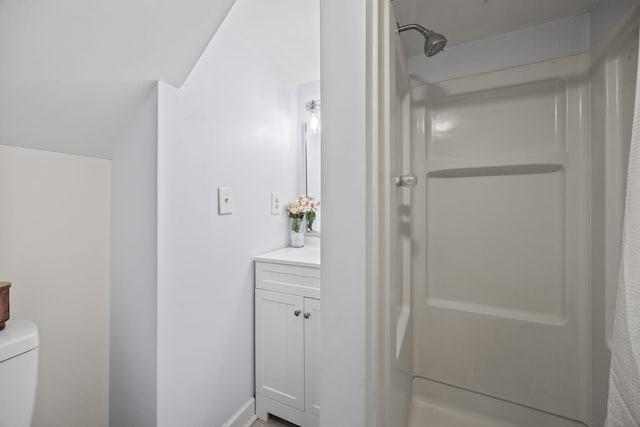 bathroom featuring vanity, toilet, and a shower