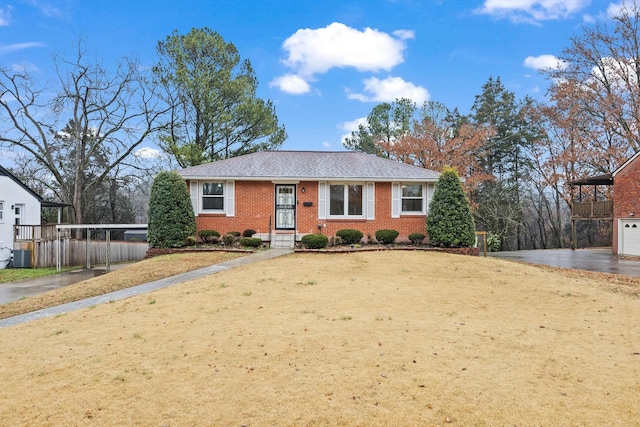 view of front facade with central AC, a garage, and a front yard