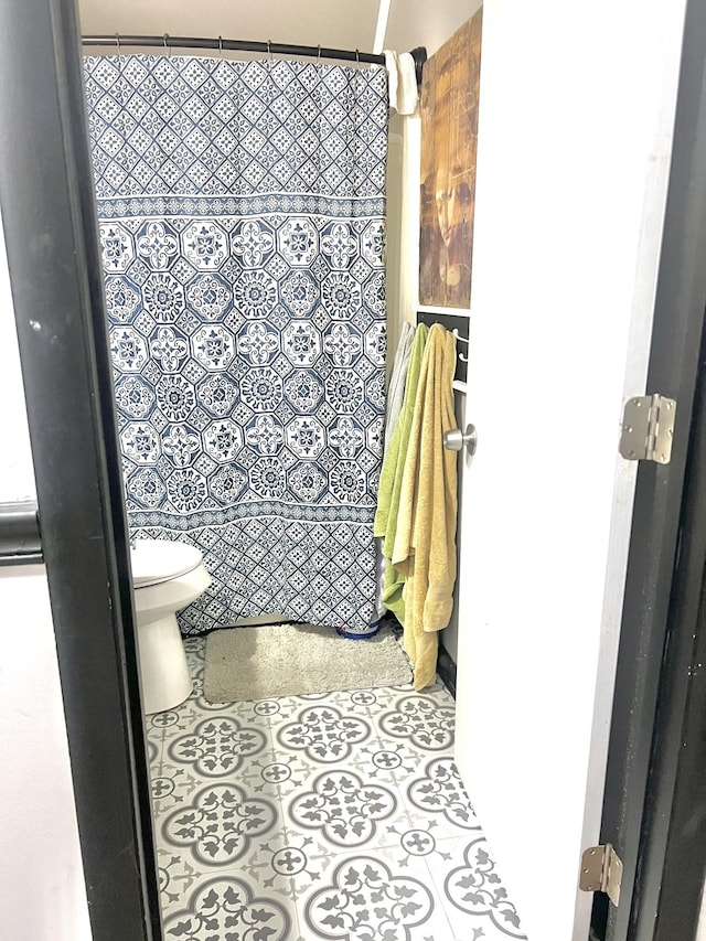 bathroom with tile patterned floors and toilet