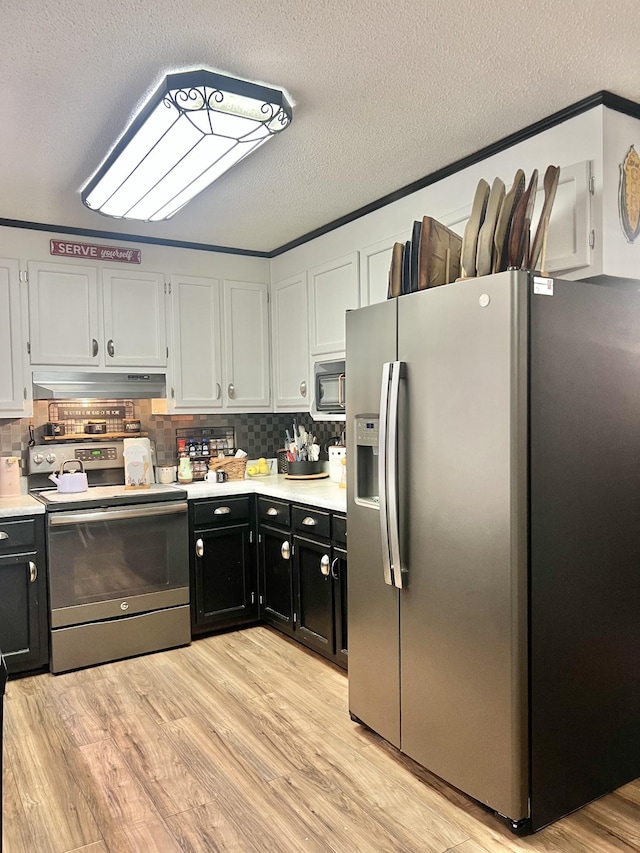 kitchen with white cabinetry, light hardwood / wood-style flooring, and appliances with stainless steel finishes