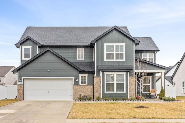 craftsman-style home featuring a garage and a front yard