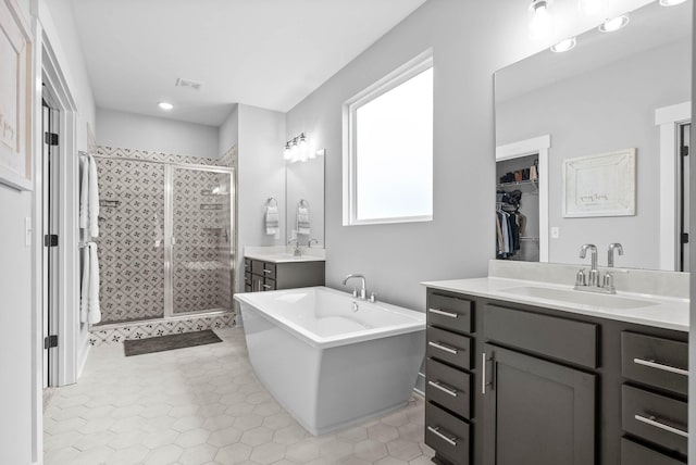 bathroom with vanity and separate shower and tub