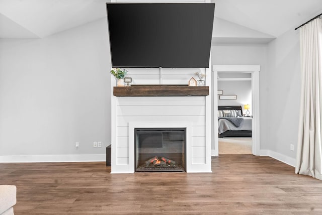 unfurnished living room with vaulted ceiling and wood-type flooring