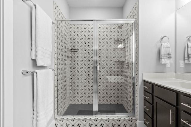 bathroom with vanity and a shower with shower door