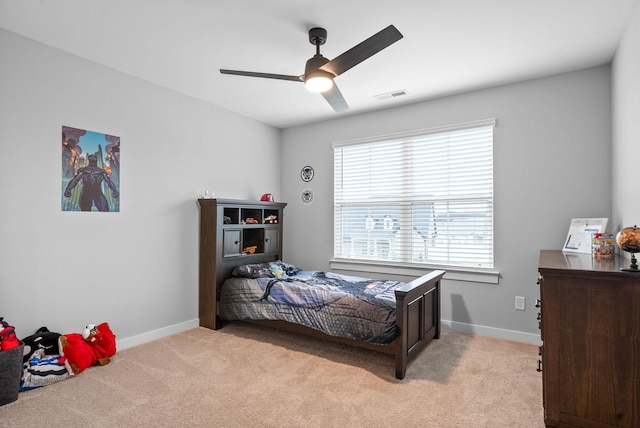 bedroom with ceiling fan and light carpet