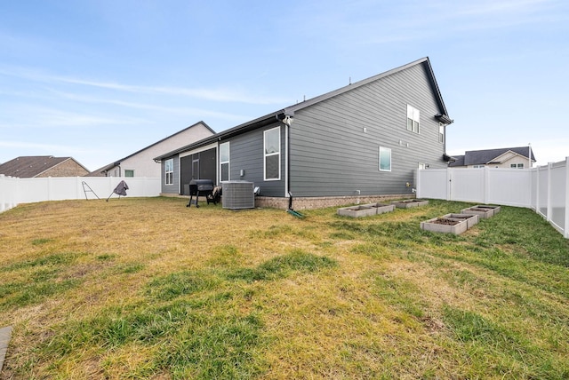 back of house featuring central AC unit and a lawn