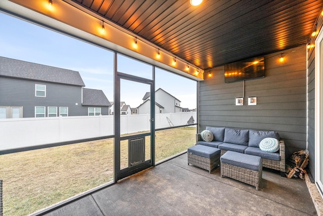 sunroom / solarium featuring rail lighting