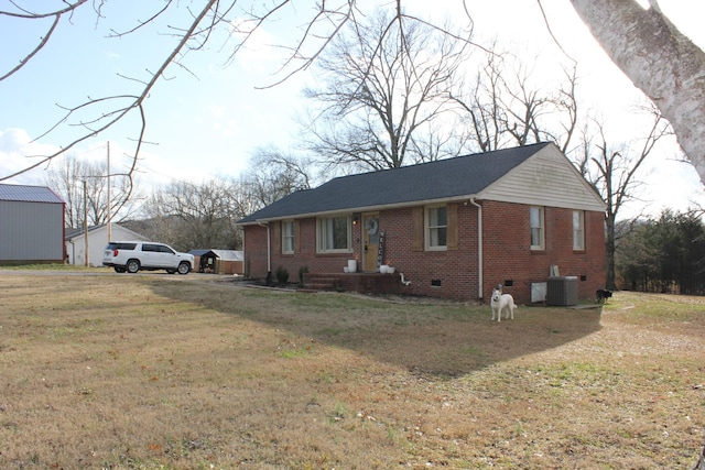 view of front of property with central AC and a front lawn