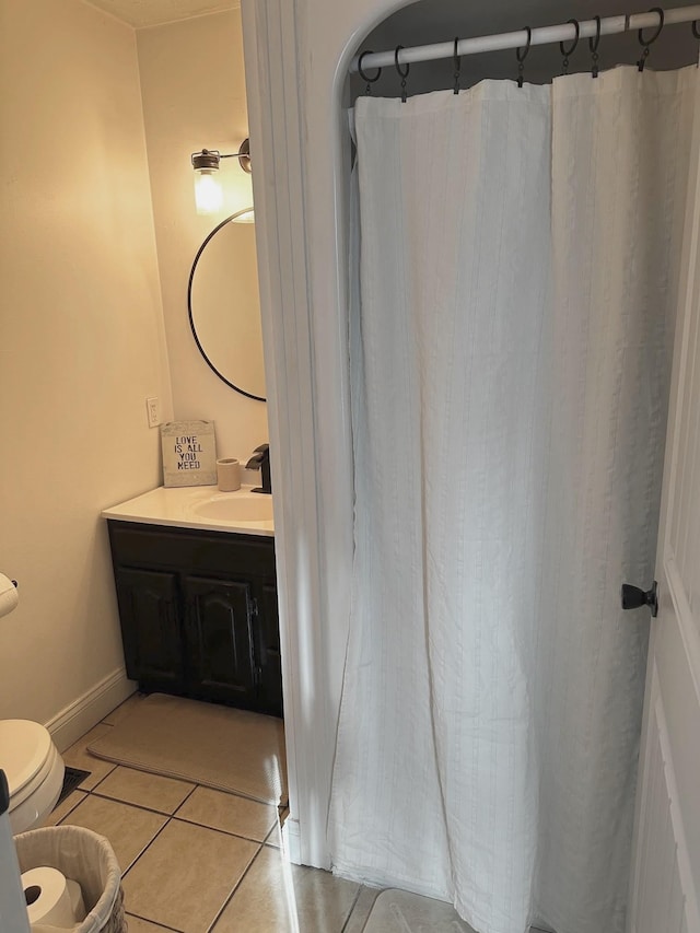 bathroom featuring vanity, toilet, and tile patterned flooring