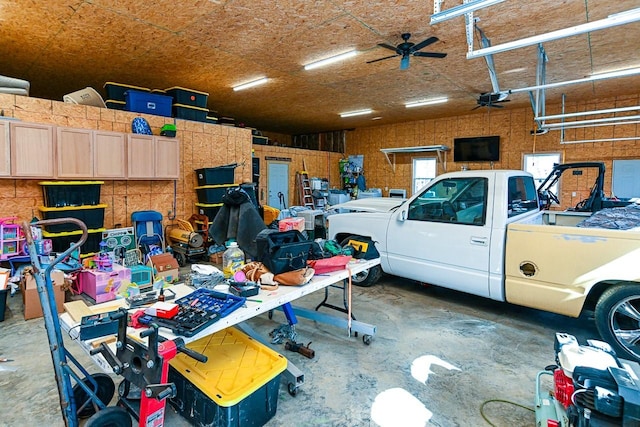 garage with ceiling fan and a garage door opener