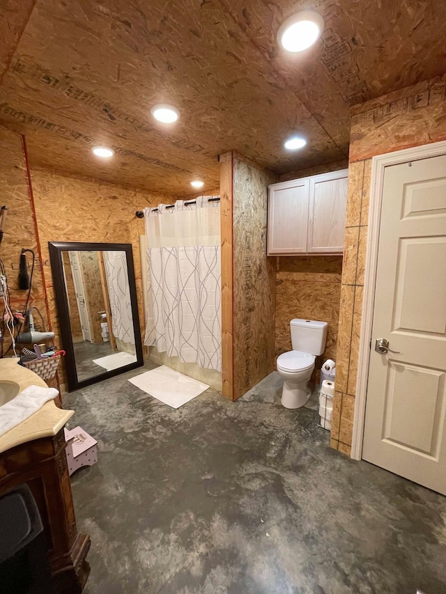 bathroom with vanity, toilet, a shower with shower curtain, and concrete floors