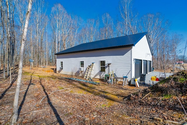 exterior space with a garage and cooling unit