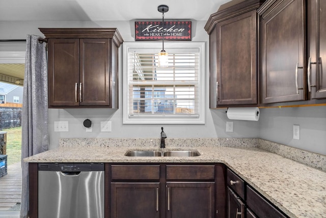 kitchen featuring sink, dishwasher, hanging light fixtures, dark brown cabinetry, and light stone counters