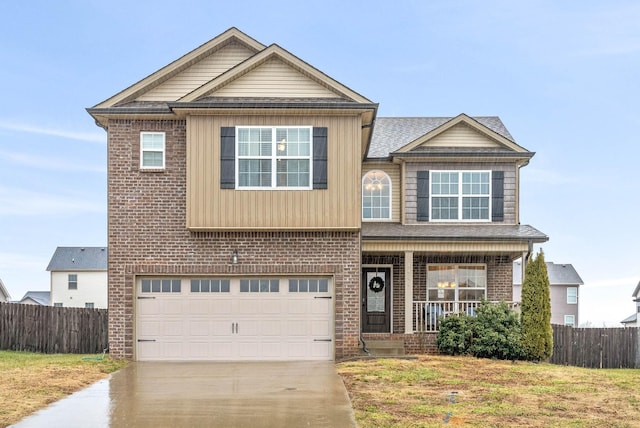 view of front of home featuring a garage, a front lawn, and covered porch