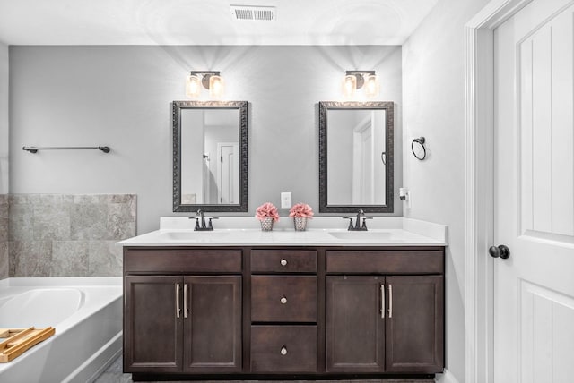 bathroom featuring a tub to relax in and vanity