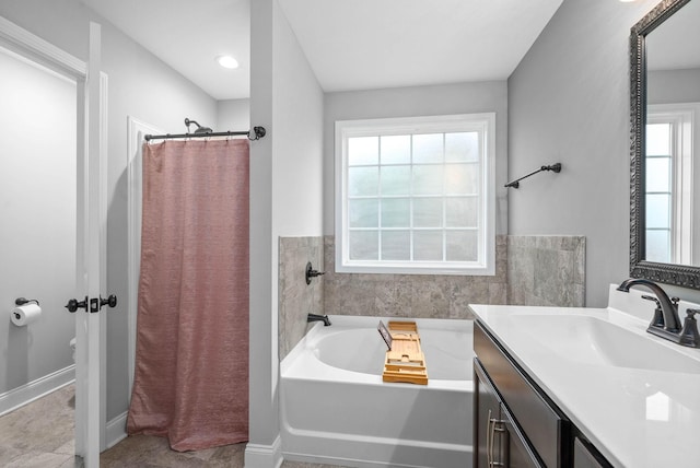 bathroom featuring vanity and separate shower and tub