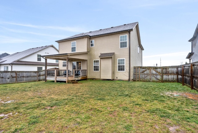 back of house featuring a wooden deck and a lawn