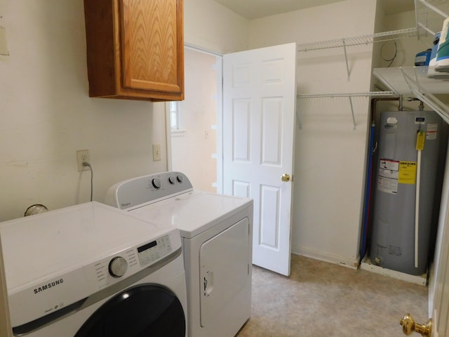 laundry area featuring washer and dryer, cabinets, and water heater