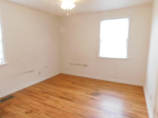 spare room featuring hardwood / wood-style floors