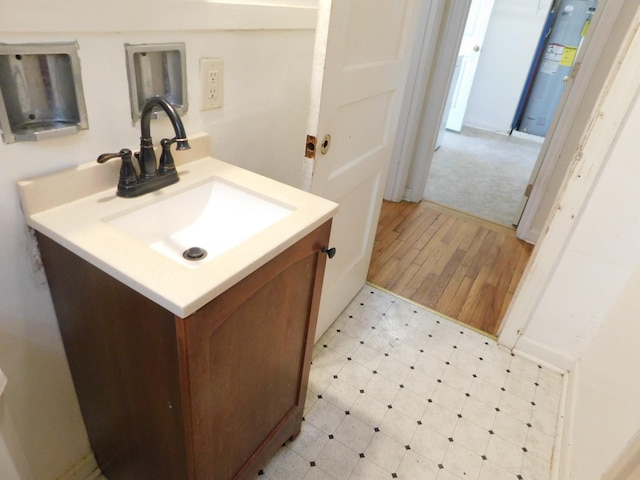 bathroom with vanity and water heater