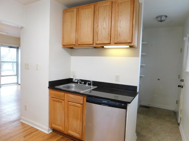 kitchen featuring dishwasher, sink, and light wood-type flooring