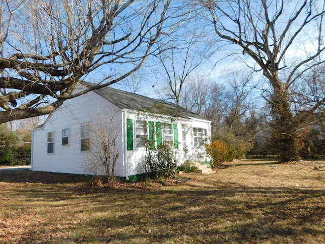 view of property exterior with a yard