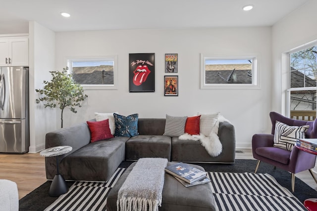 living area featuring recessed lighting, baseboards, and wood finished floors