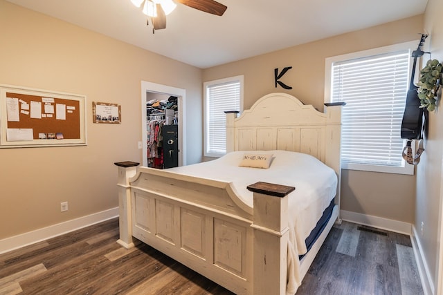 bedroom with ceiling fan, dark hardwood / wood-style flooring, and a spacious closet