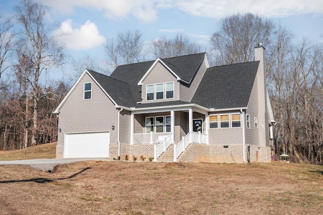 view of front of property with a garage, covered porch, and a front lawn