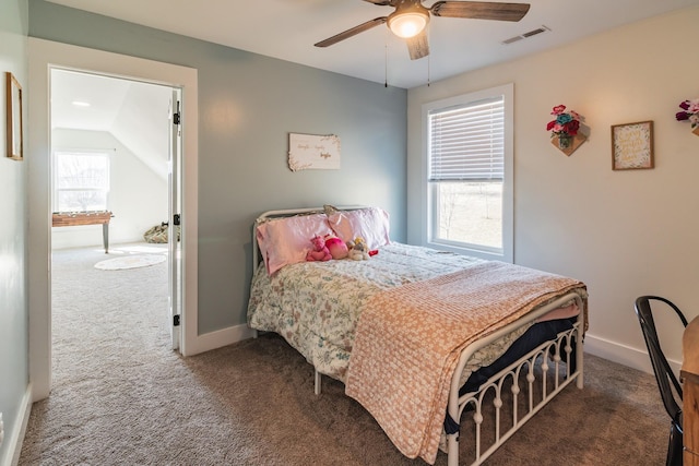 bedroom with ceiling fan, lofted ceiling, and dark colored carpet