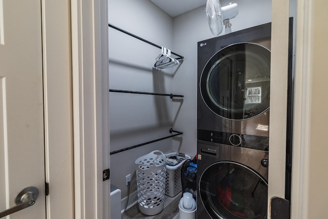 clothes washing area featuring stacked washing maching and dryer