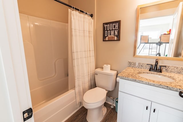 full bathroom featuring hardwood / wood-style flooring, vanity, shower / tub combo with curtain, and toilet