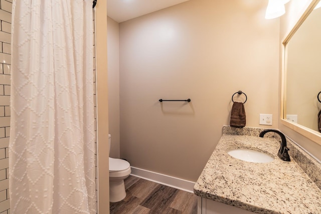 bathroom with a shower with curtain, wood-type flooring, toilet, and vanity