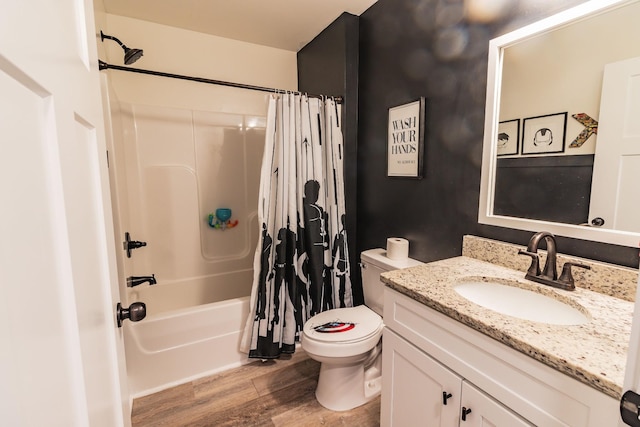 full bathroom featuring shower / tub combo with curtain, hardwood / wood-style floors, vanity, and toilet