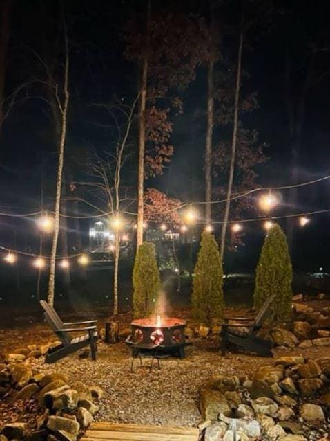 yard at night featuring an outdoor fire pit