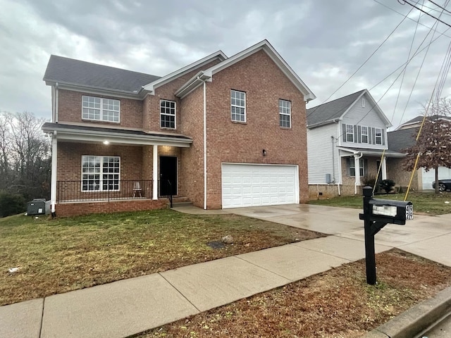 view of property featuring a garage, a front lawn, and covered porch