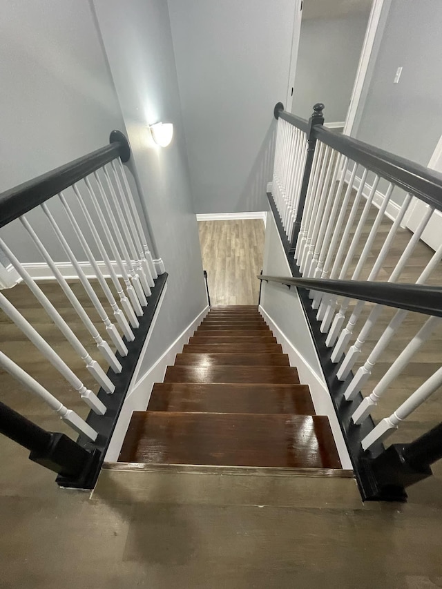 stairway featuring hardwood / wood-style flooring