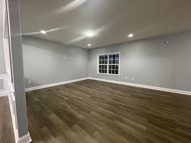 spare room with dark wood-type flooring