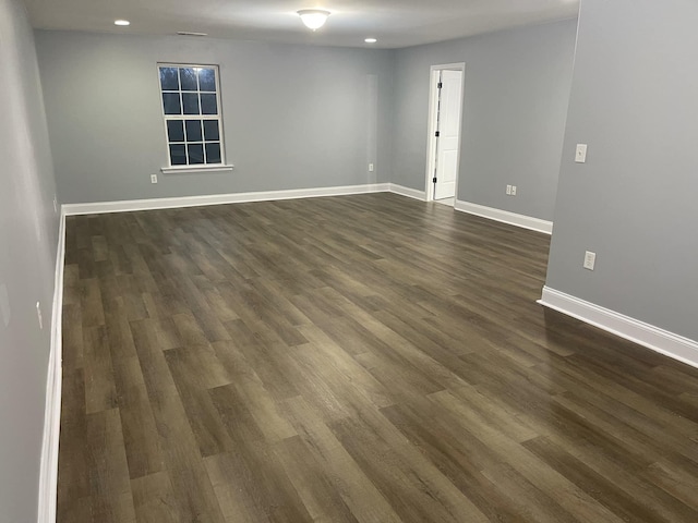 empty room with dark wood-type flooring