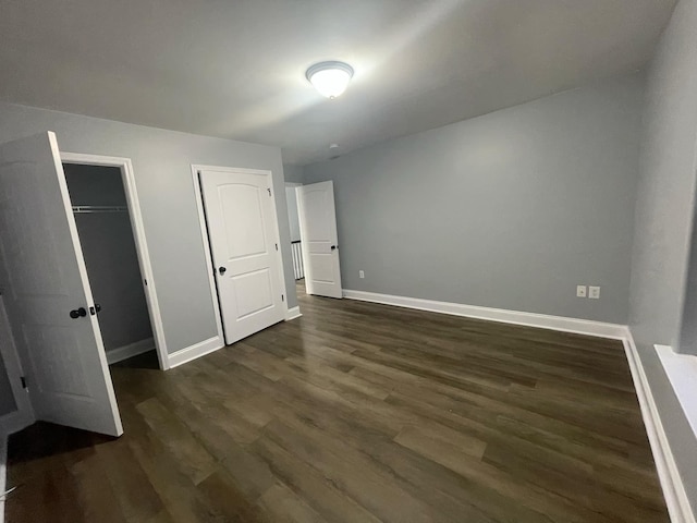 unfurnished bedroom featuring dark wood-type flooring