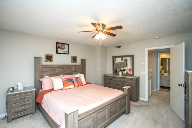 carpeted bedroom featuring ceiling fan and a textured ceiling