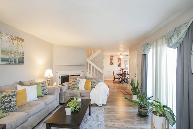 living room with ceiling fan and light hardwood / wood-style floors