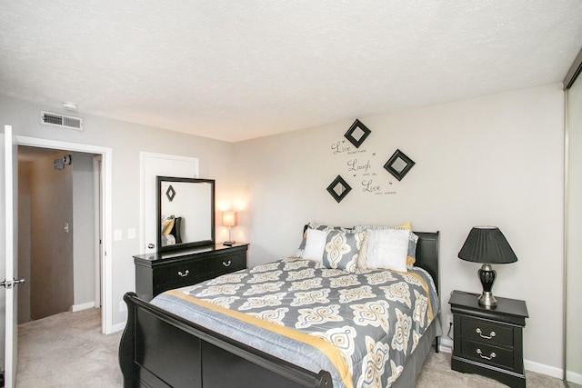 carpeted bedroom with a textured ceiling