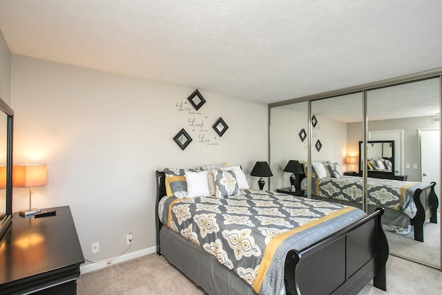 bedroom with light colored carpet, a closet, and a textured ceiling