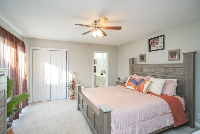 carpeted bedroom with ceiling fan, ensuite bath, and a closet