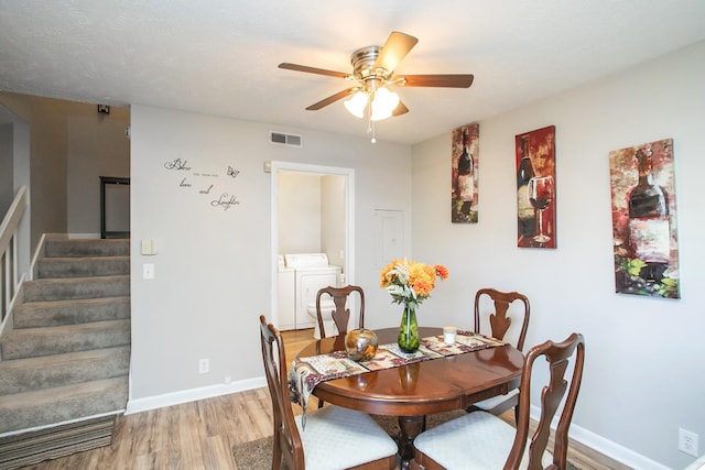 dining area with wood-type flooring, washing machine and clothes dryer, and ceiling fan