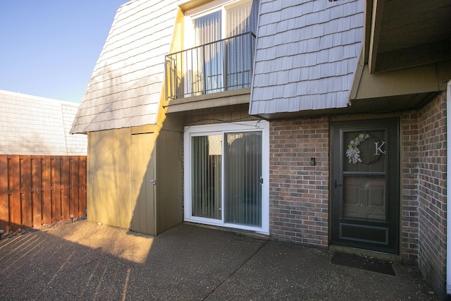 back of property with a balcony and a patio area