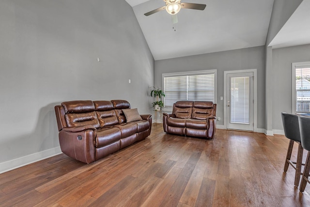 living room featuring wood-type flooring, high vaulted ceiling, and ceiling fan